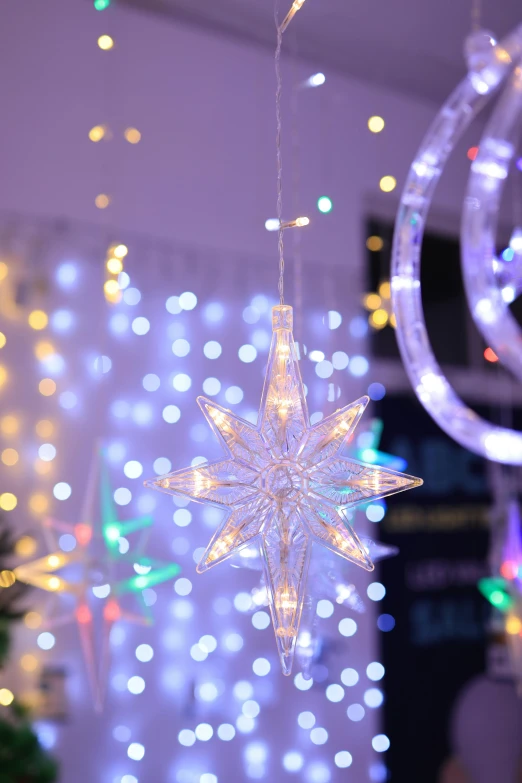 lights are hanging in the background of a christmas tree