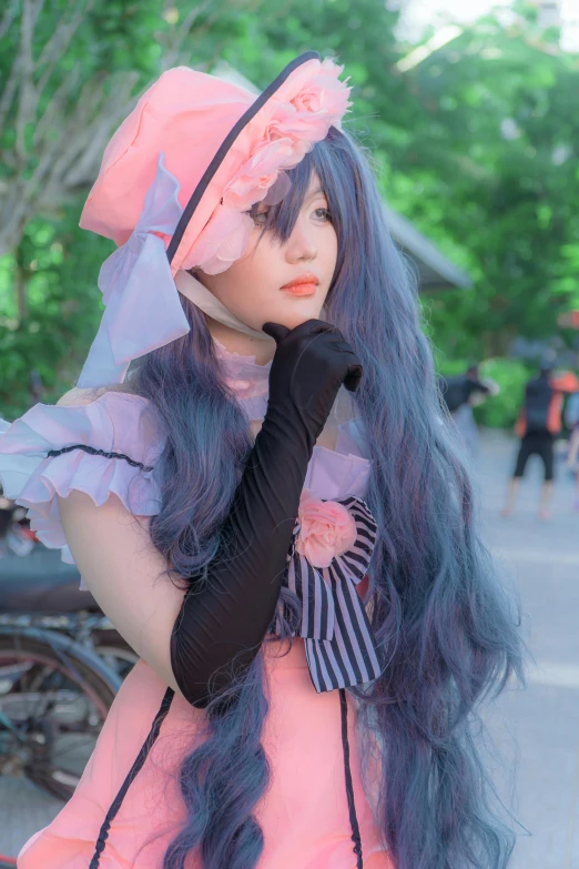 a very long haired woman with purple hair and wearing a pink dress