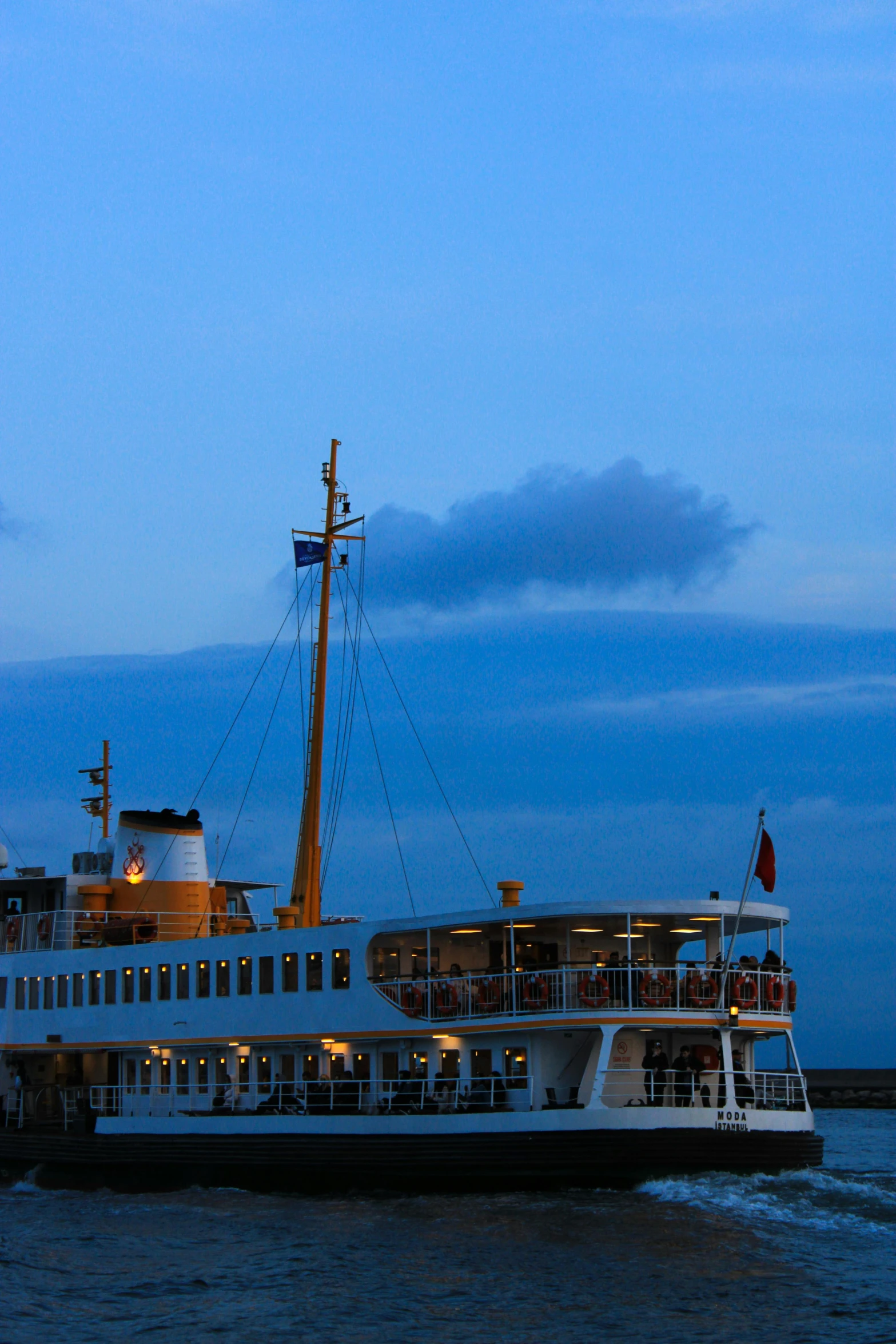 a large boat at dusk on a body of water