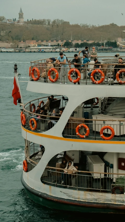 a group of people riding on the back of a ferry boat