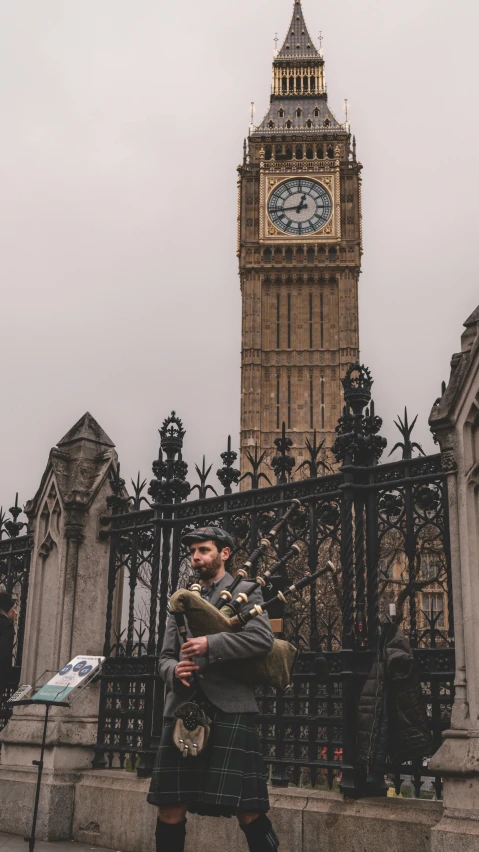 there is a person that is standing in front of the clock tower