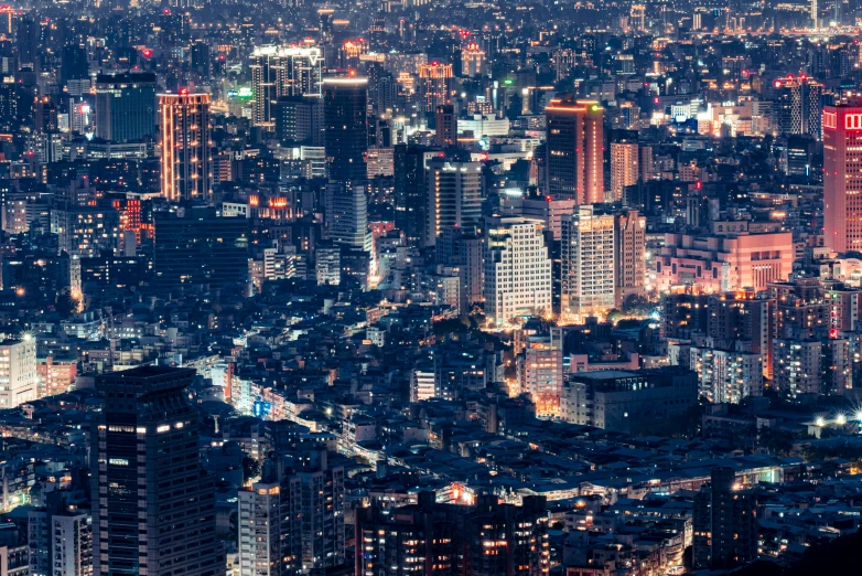 the city skyline at night is lit up in red and blue