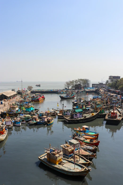 a harbor filled with lots of small boats on a lake