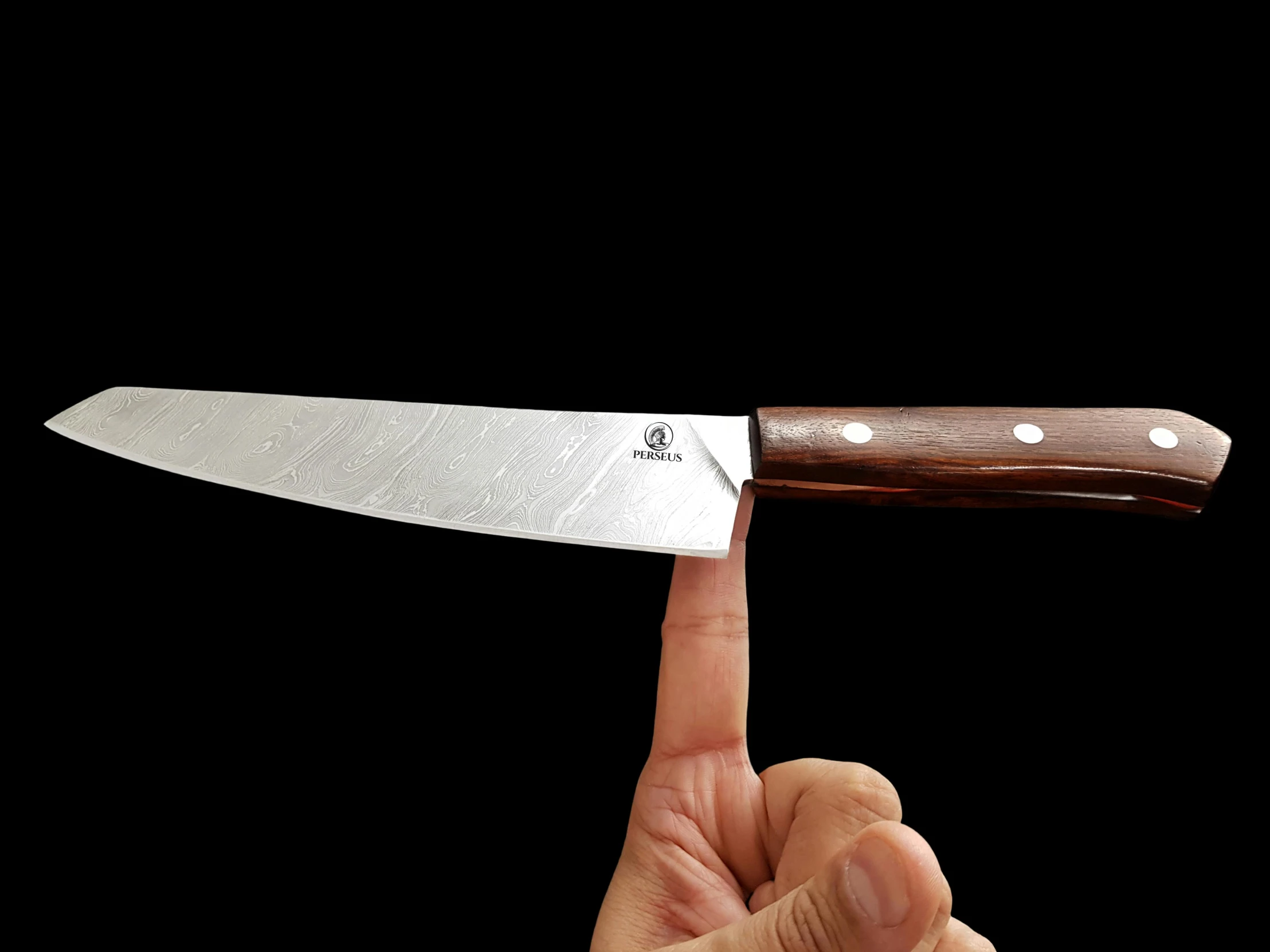 a person pointing towards a kitchen knife with one finger