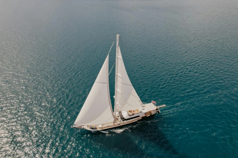 the large white sailboat is sailing in the water