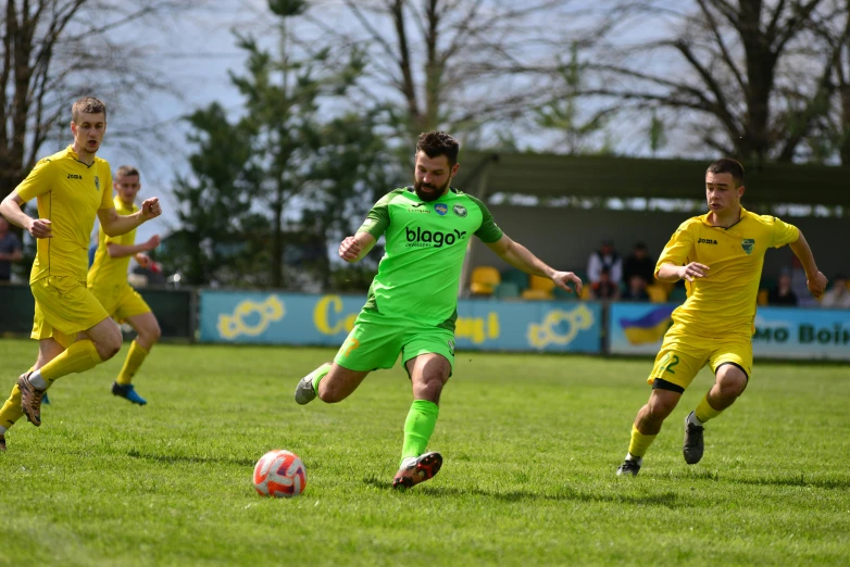 a group of young men playing soccer against each other on a field