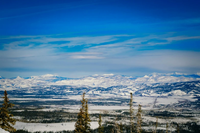 a man is skiing on the slopes in front of snowy mountains