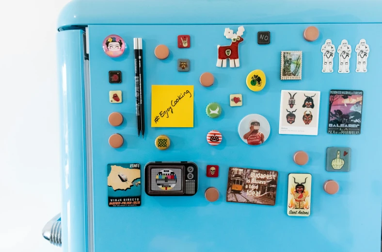 the refrigerator has a lot of magnets on it