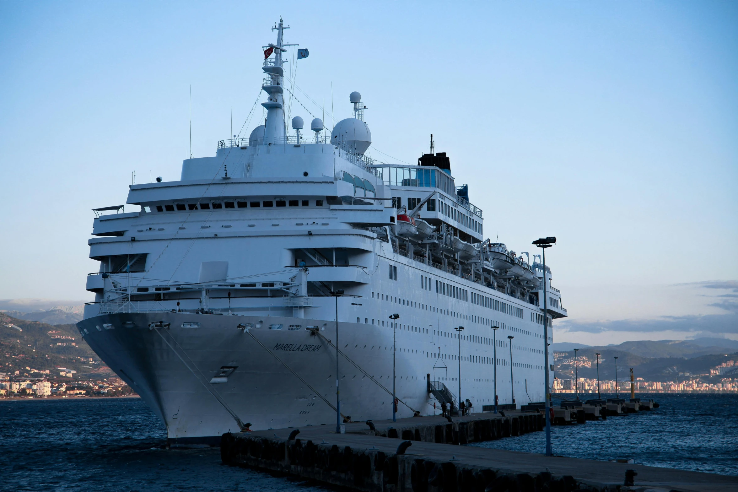 a large cruise ship parked next to the sea