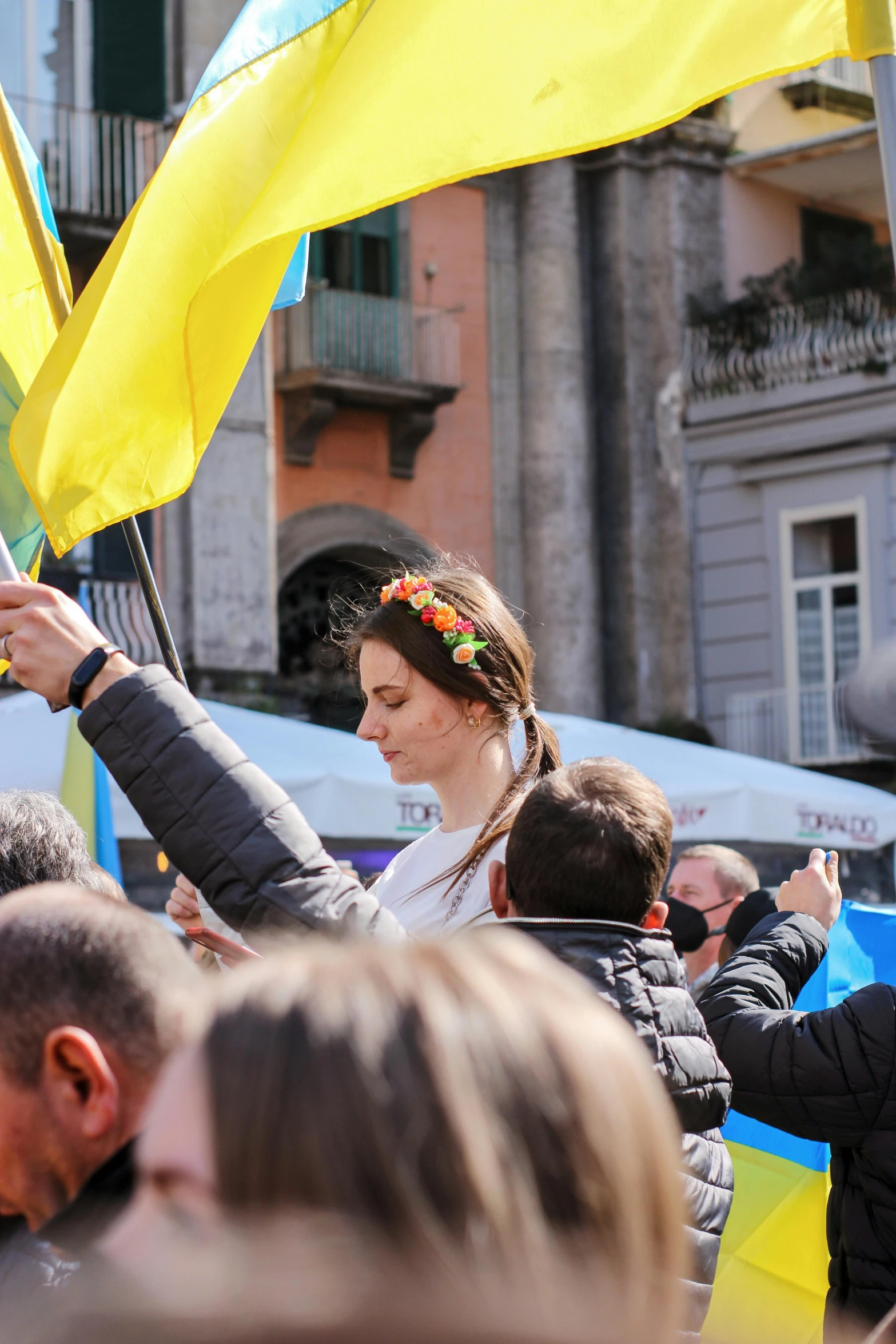 a group of people standing around holding flags