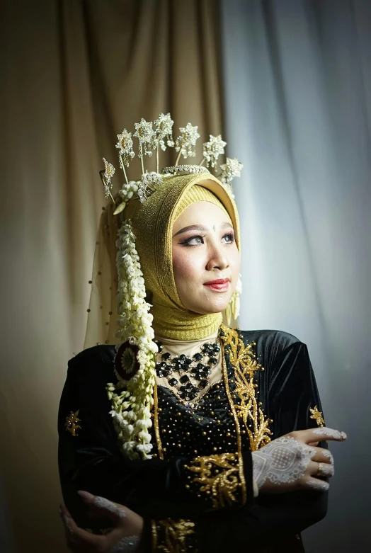 a woman wearing a head piece and dress