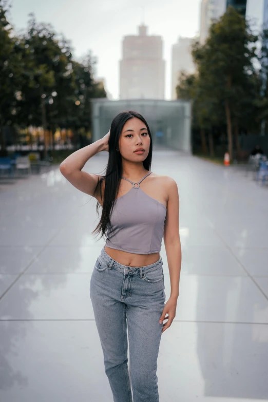 an asian female posing on the sidewalk