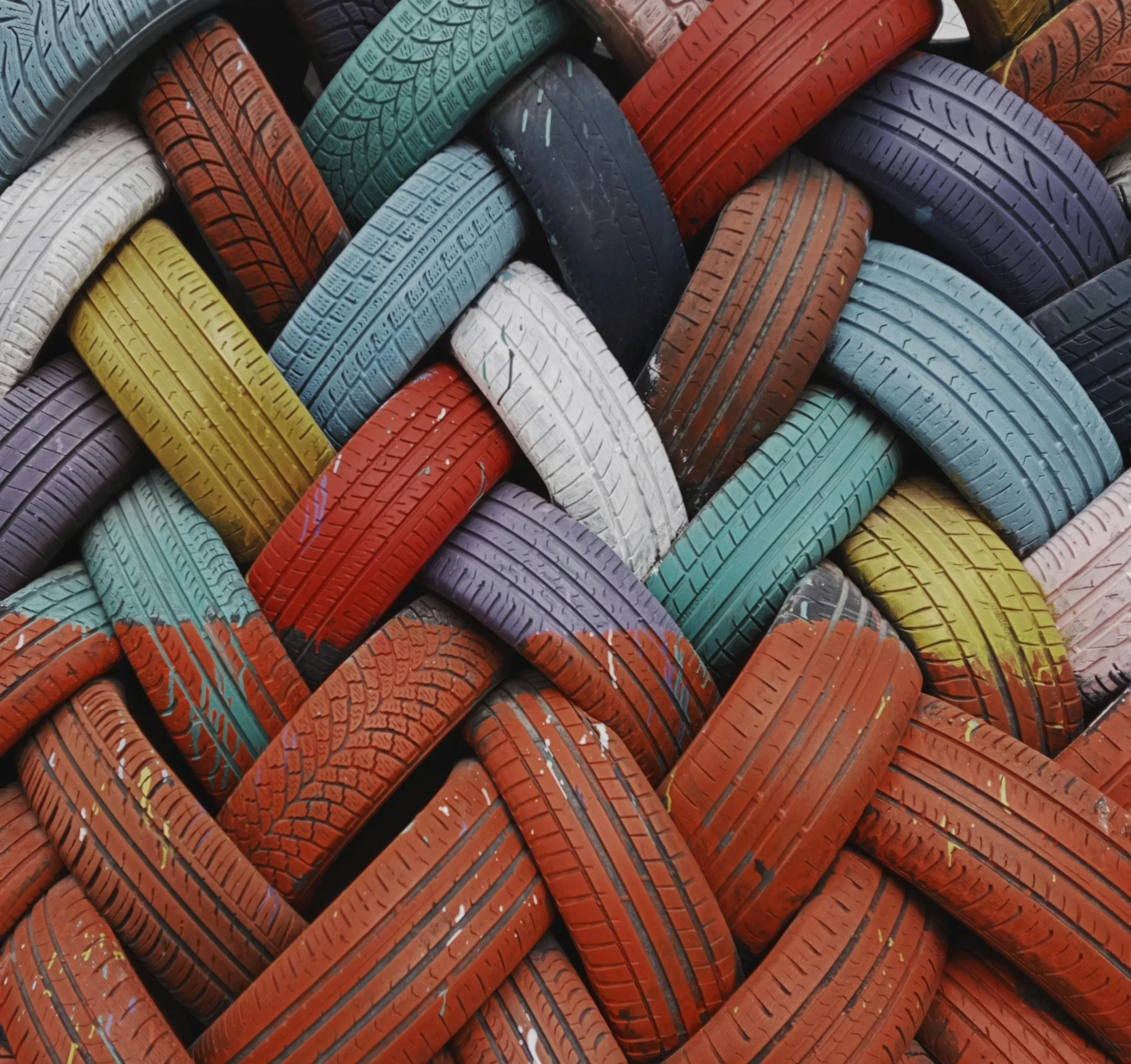 many different colored tires stacked together