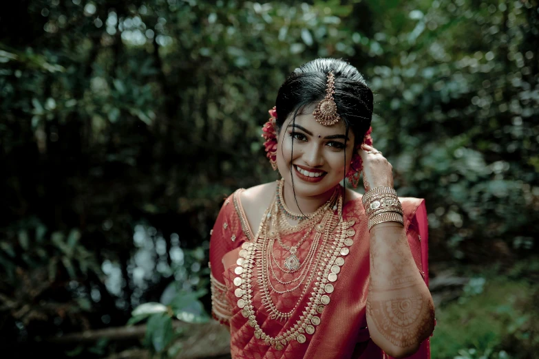 an attractive lady wearing a sari is on her cell phone