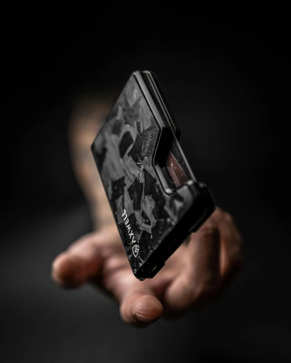 a man holding up a piece of electronic equipment