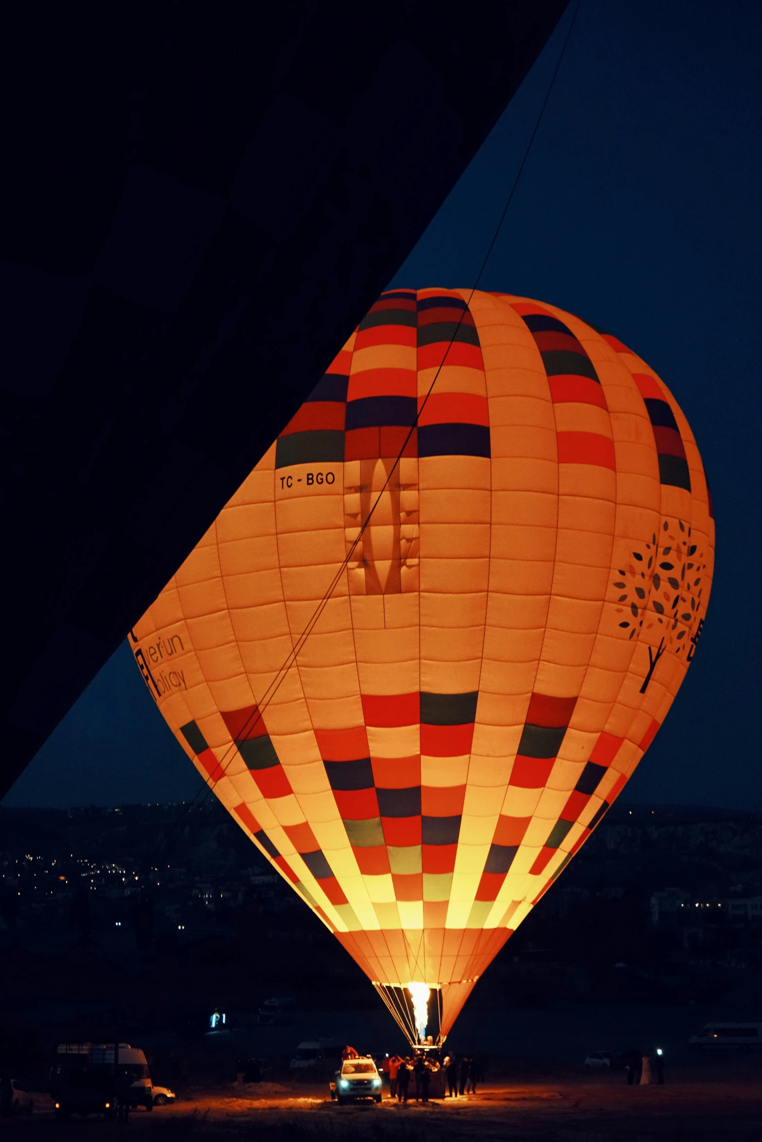 the glow of a multicolored  air balloon is illuminated