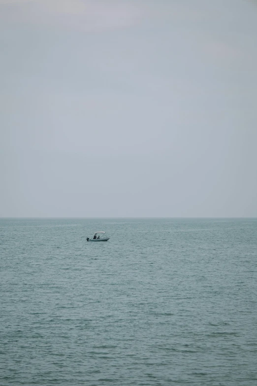 a lone boat sailing across the ocean