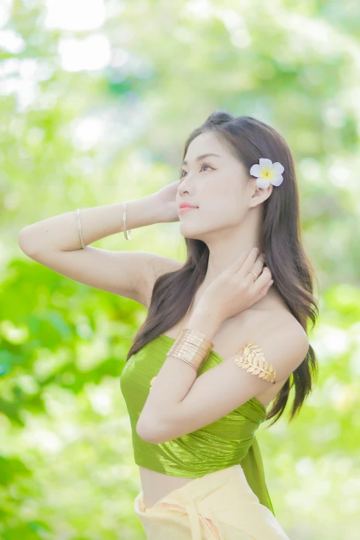 an image of a girl holding a flower in her hair