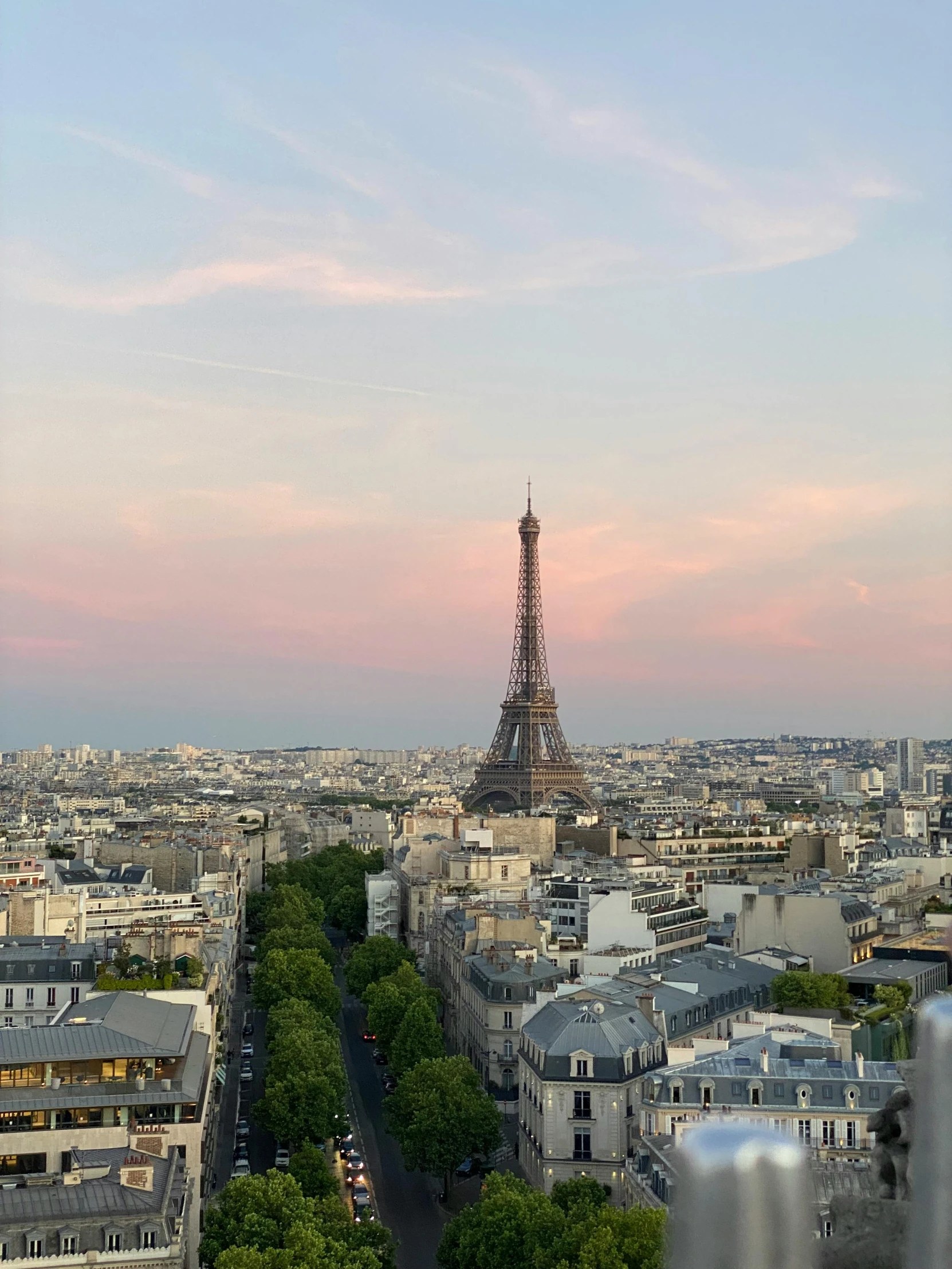 the eiffel tower sits in the distance behind the skyline