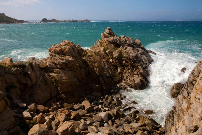 rocks in the ocean with waves crashing onto them