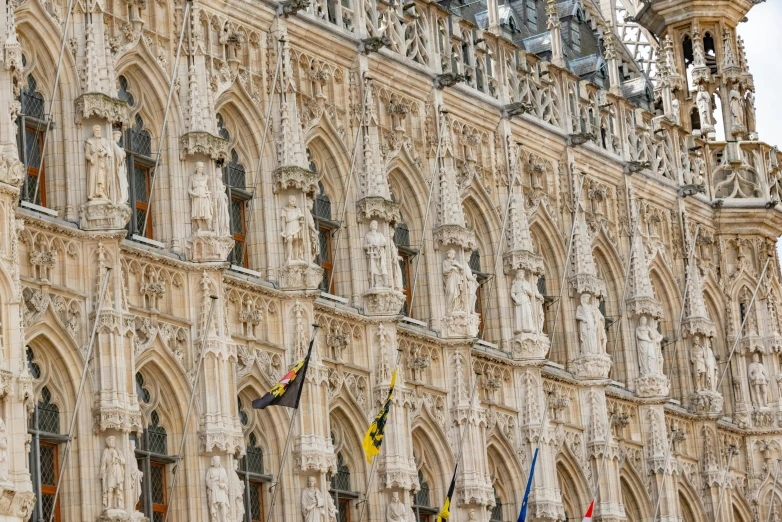 a large ornate building with stone carved details and statues