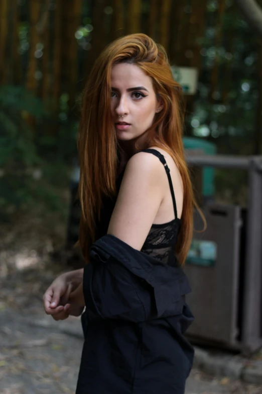 woman with long red hair wearing a black dress