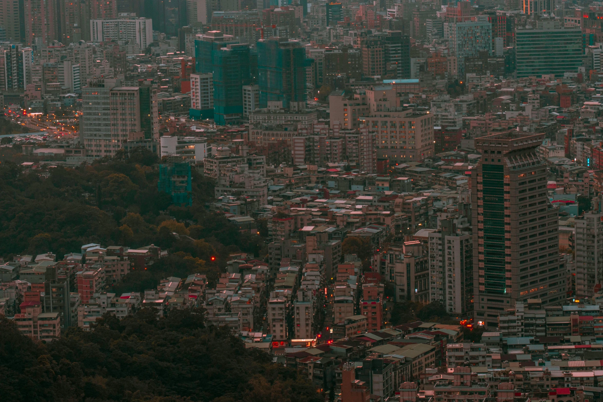 some tall buildings in the city with a sky background