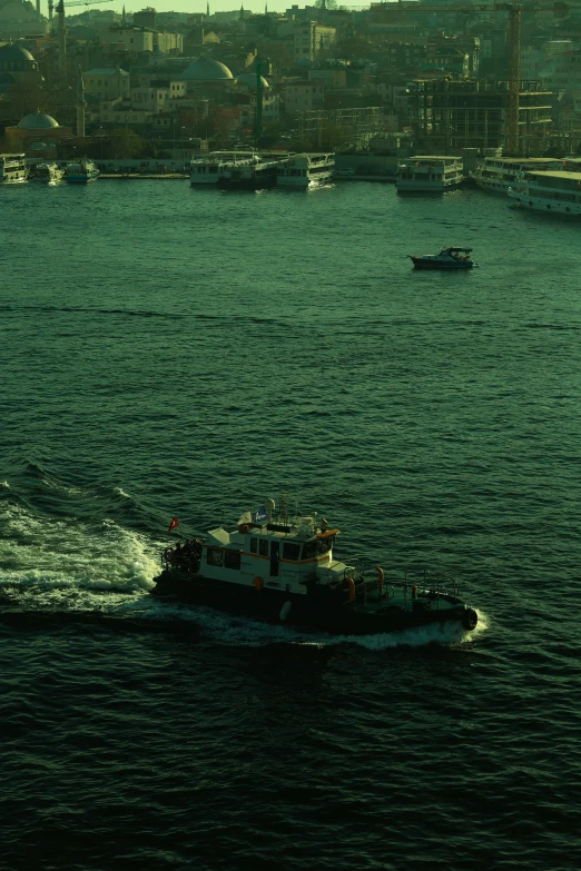 a boat sails on the water in front of a city