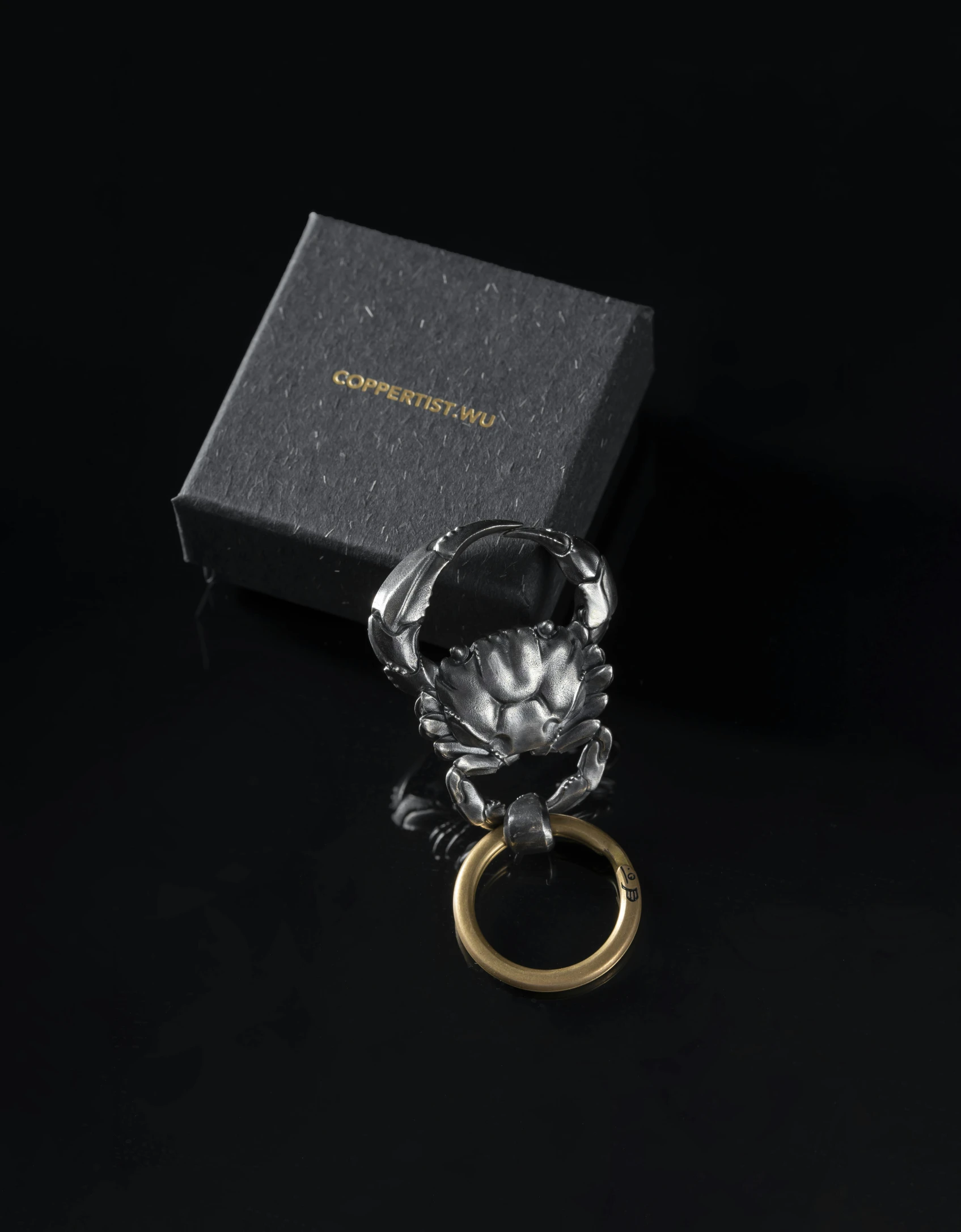 a ring with a golden band on top of a black box