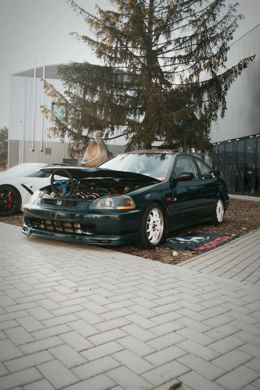 the car is being worked on by a man