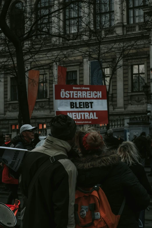 several people gathered around with signs on the sides