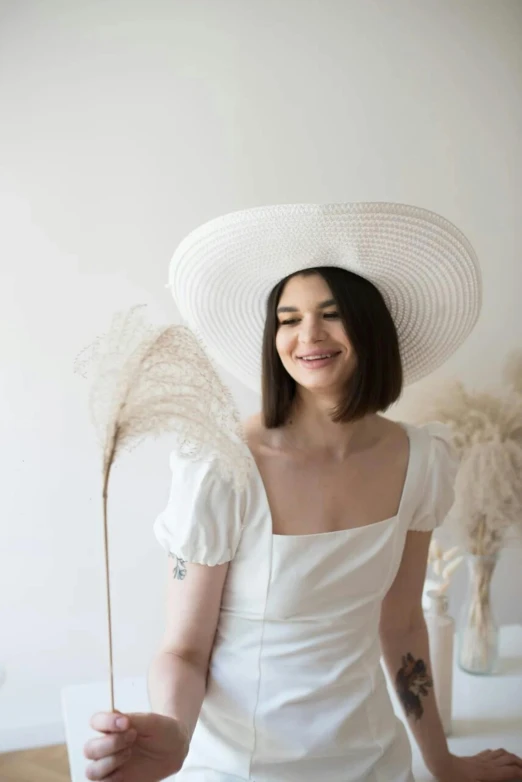 a woman in white hat sitting on table