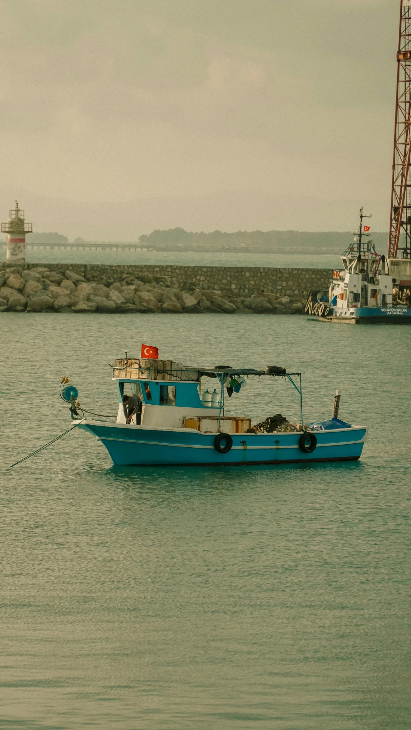 a blue and white boat in water next to shore