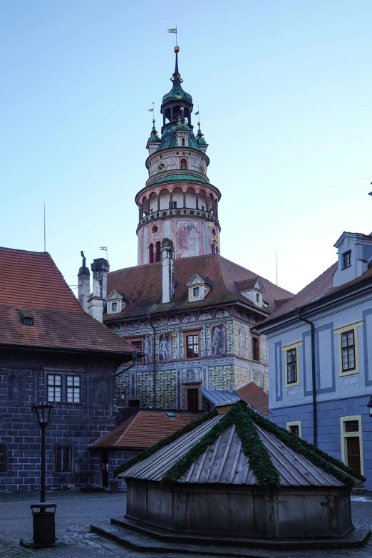 a building has a red and yellow clock tower