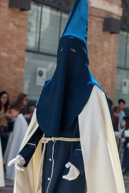 an individual wearing a black and white outfit with blue hood