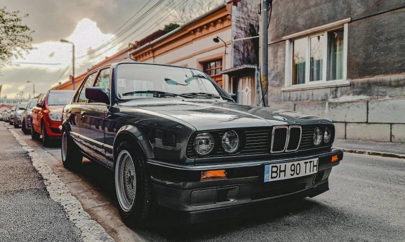 a bmw car parked on a street in front of buildings