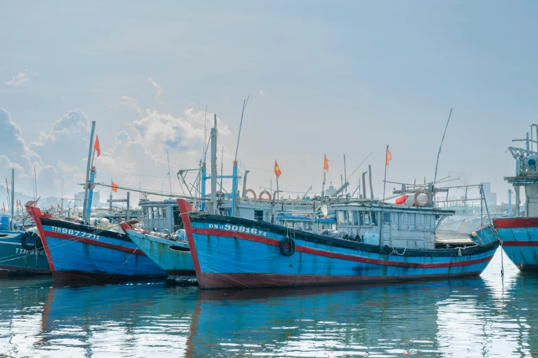 two blue boats are parked next to each other