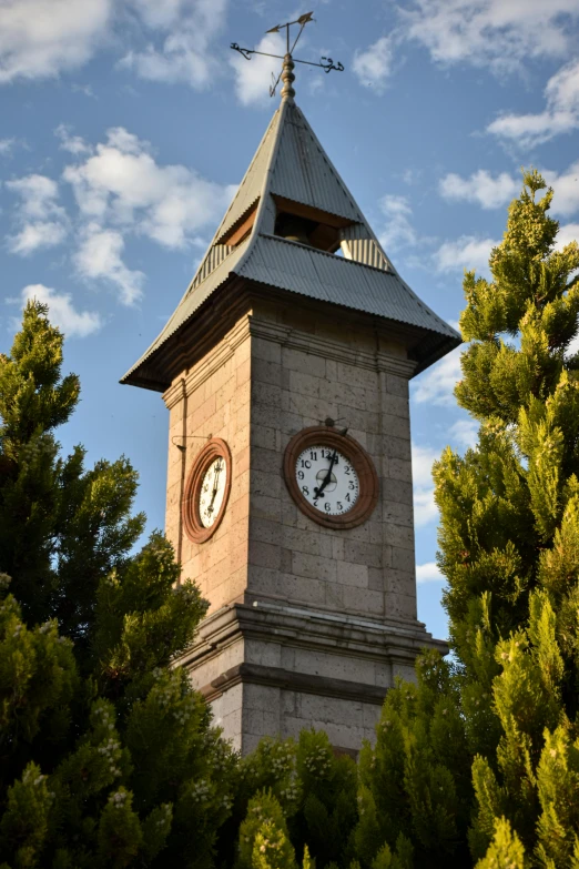 a clock tower with a weather vane and roof