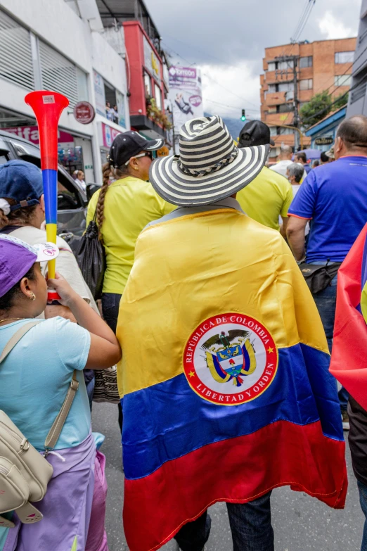 several people with hats are walking down the street