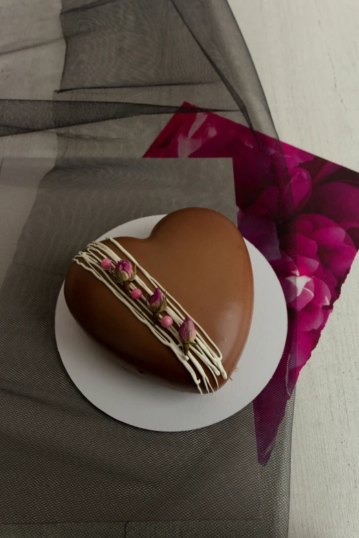 an egg is sitting on a plate near pink and purple material