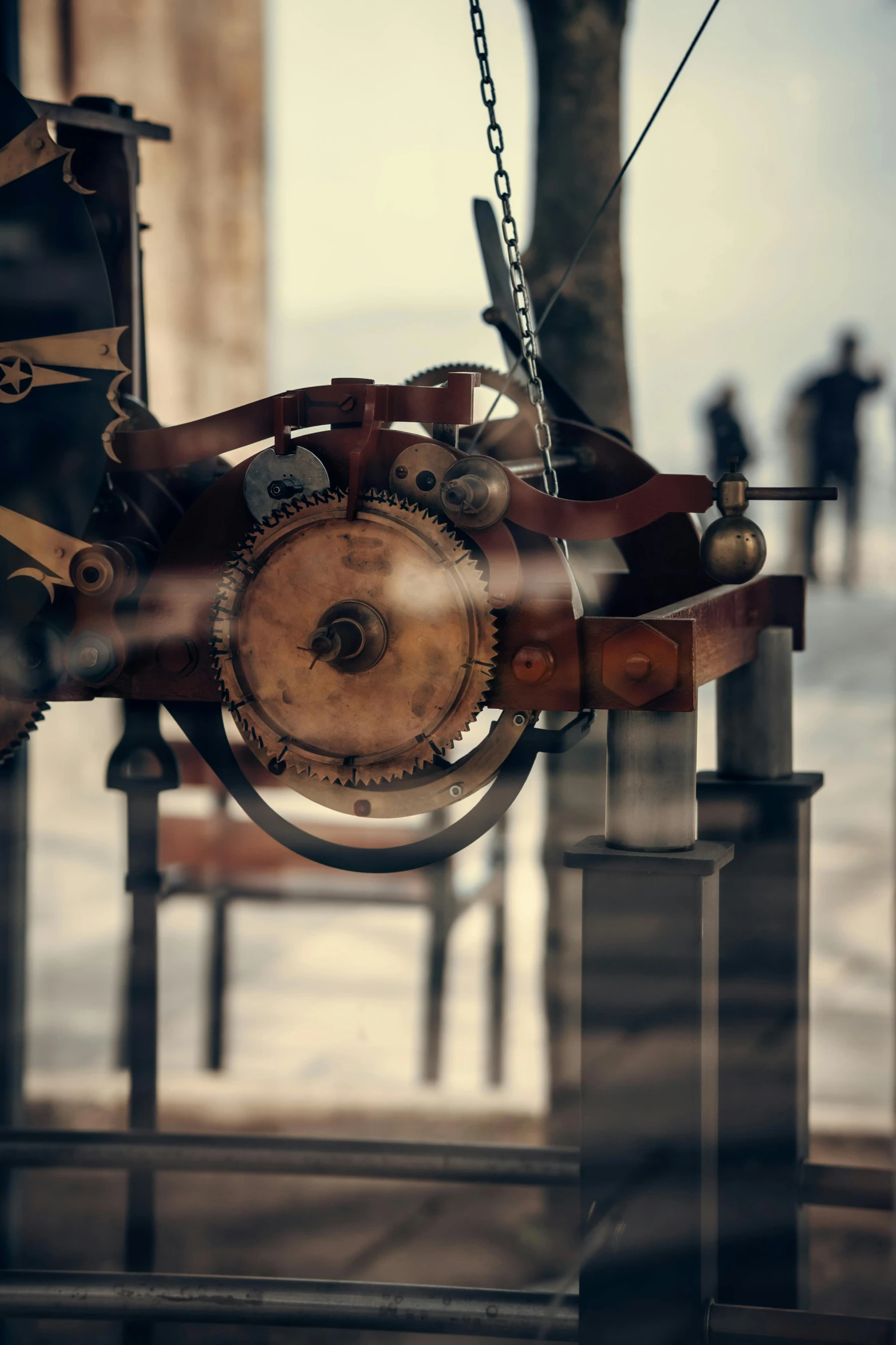 an old clock is suspended from a rope