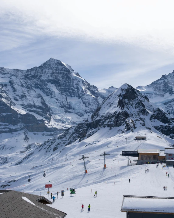 several people standing in the snow at the bottom of a ski slope