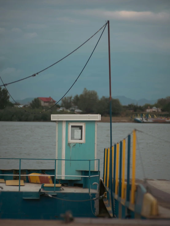 the boat is docked on the water near a dock