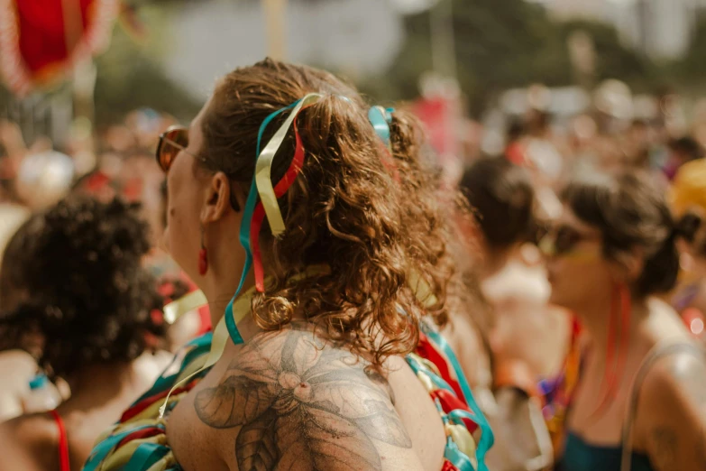 a woman with tattoos stands in front of others