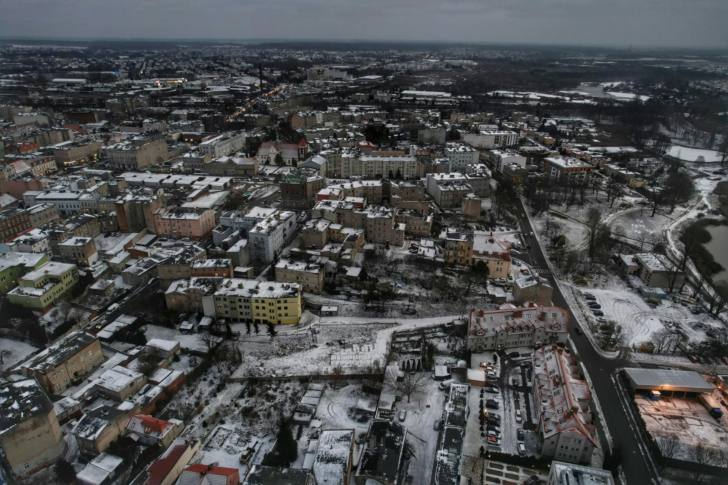 a aerial view shows snow covered streets and houses