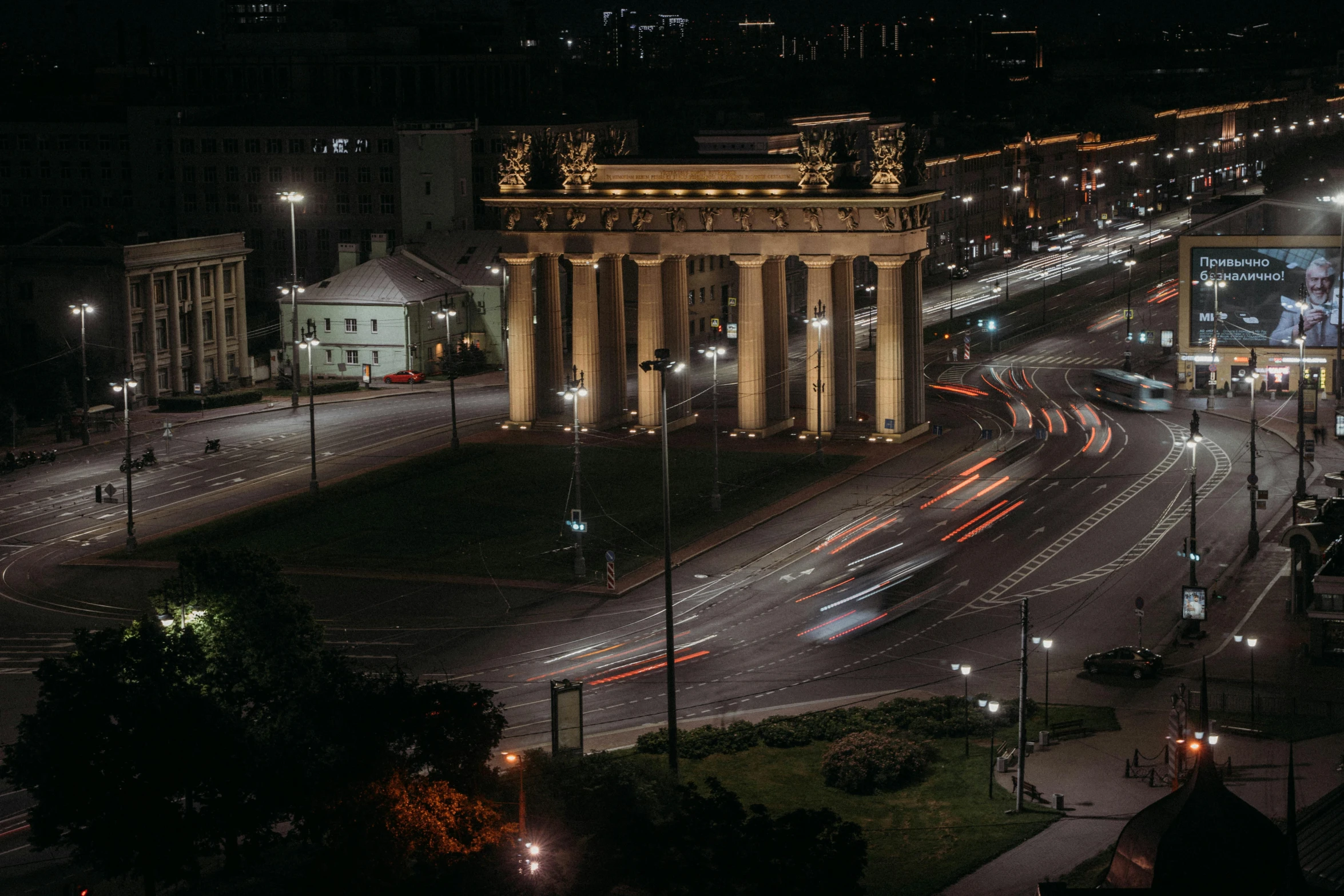 a nighttime time po of an old building and street with lots of traffic