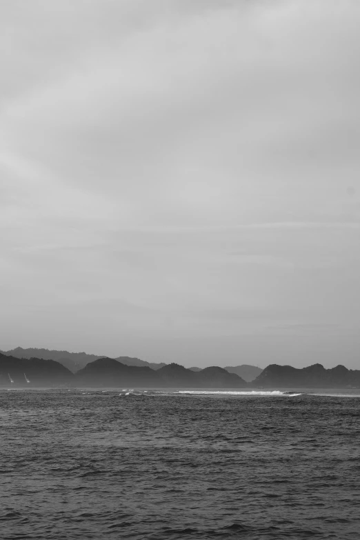 a boat traveling across the ocean on top of a hill