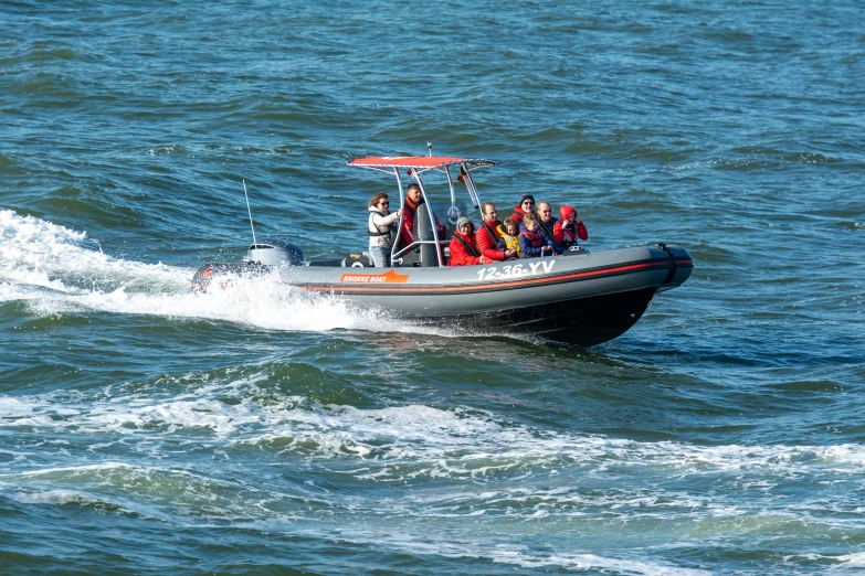 group of people on boat riding in open water