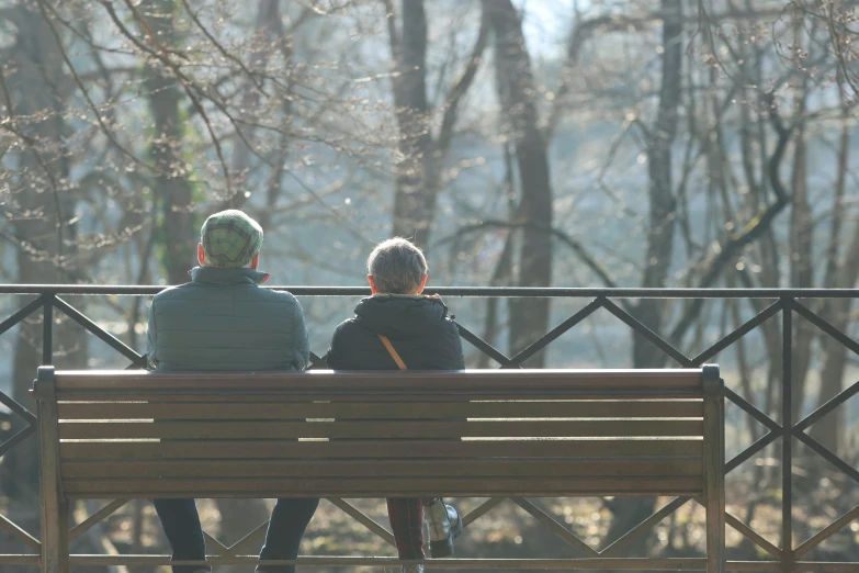 a couple of people that are sitting on a bench