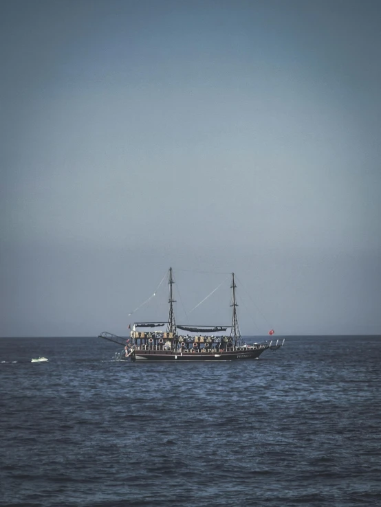 a large boat sailing across a wide body of water